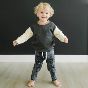  Happy toddler modeling the Olive + Scout Ryker Crewneck Sweatshirt