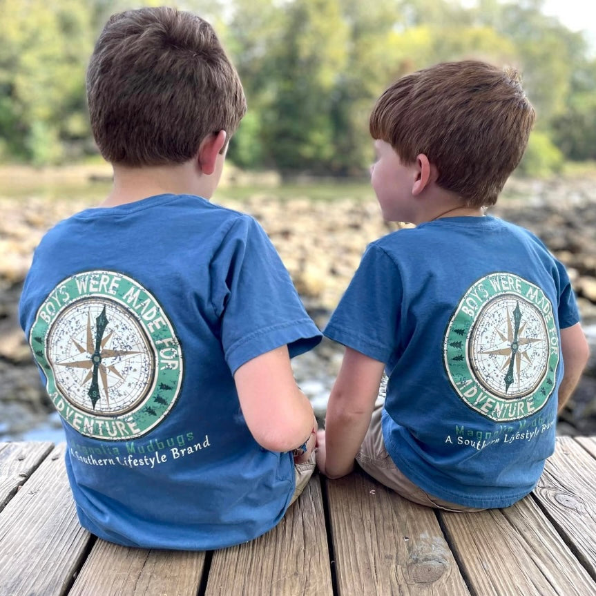 Two boys sitting on dock fishing wearing the Magnolia Mudbugs Adventurous Boy Tee